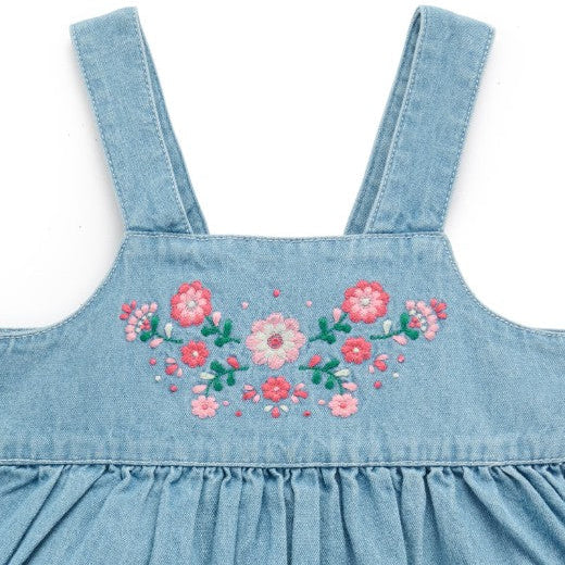 Blue denim dress with floral embroidery on a white background