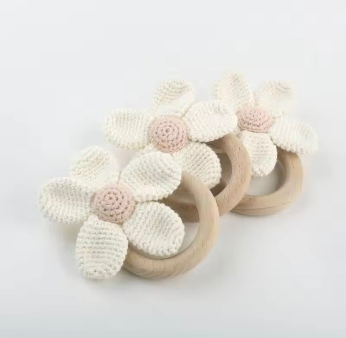 Floral-patterned teething rings on a light gray background