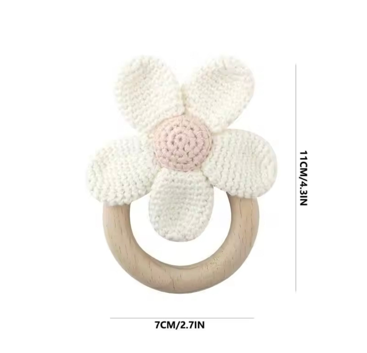 Floral baby teether with wooden ring and measurements on a white background