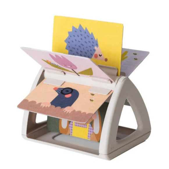 Children's book stand with colorful books featuring animals on a white background
