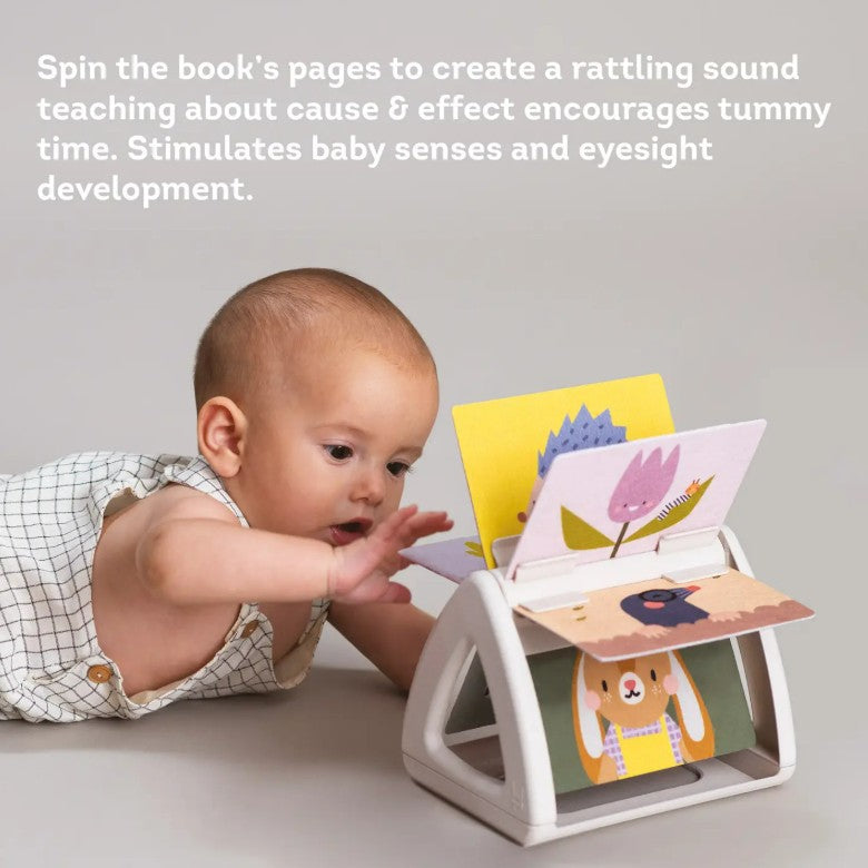 Baby interacting with a developmental toy that spins book pages.