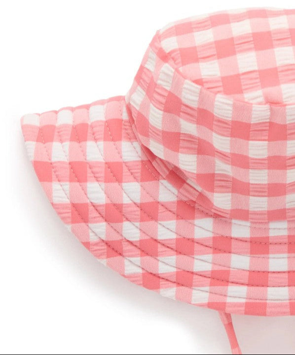 Pink and white checkered bucket hat on a white background